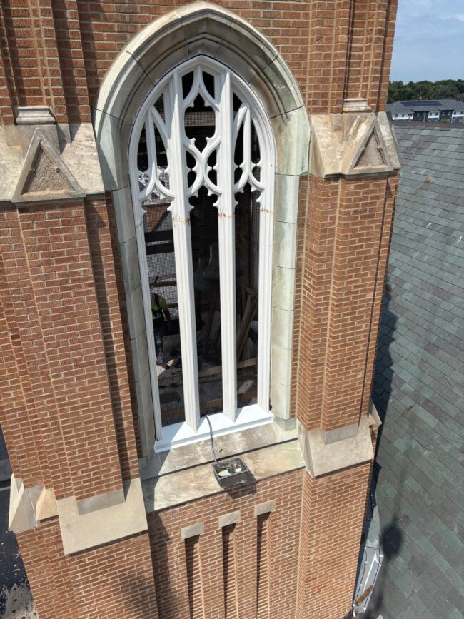 Restored Gothic church window with custom white wood tracery